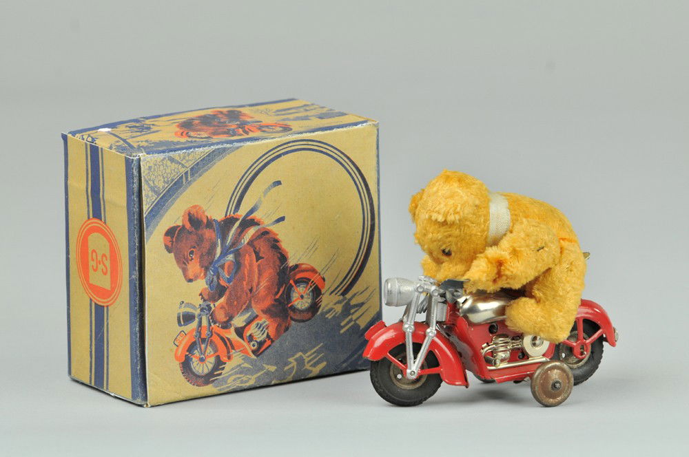 GUNTHERMANN BEAR RIDING MOTORCYCLE: Gunthermann, Bear on Motorcycle toy, fabric fur, tin body, US Zone, Germany, tin, windup okay, reproduction box. 4 1/2" l. x 3 3/4" h. Handle bars broken off & missing; otherwise (VG Cond.) 4 1/2" l.