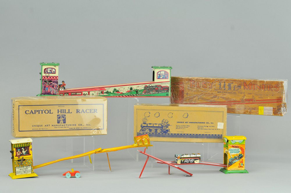 LOT OF THREE RAMP TOYS: Boxed examples, includes Hill Billy Express and Capital Hill Racers, each comes with vehicle, lithographed tin, key winds allow back and forth motions on ramp. 10 1/2" - 16 1/2" l. One box has flaps m