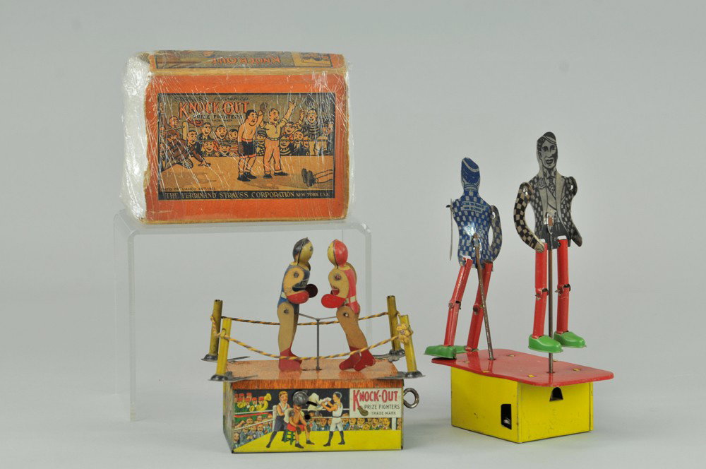 LOT OF TWO BOXER TOYS: Lithographed tin and wood, includes Strauss "KNOCK-OUT BOXERS" with box, and two tin boxing figures made in Canada on base, both key wind driven. 6" - 8 1/2" h. Box missing box flaps, crushed, (Fair C