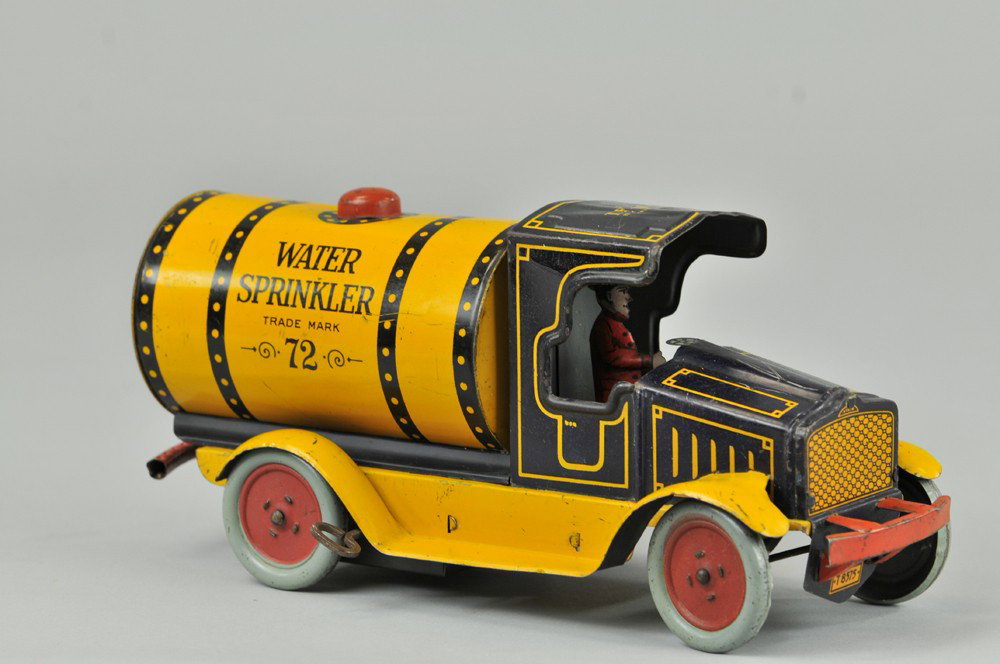 STRAUSS WATER SPRINKLER TRUCK: 1926, lithographed tin, done in dark blue cab with yellow tank body, has red filler cap and bumper, rear sprinkler bar, key wind mechanism. 10 1/2" l. Denting to roof, scratches, otherwise (VG Cond.) 