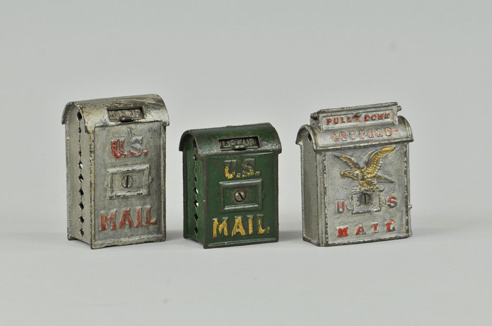 LOT OF THREE U.S. MAIL BOX STILL BANKS: Kenton, cast iron, two painted in silver with red lettering, one done in green, gold trim, two have opening coin slots. 3 1/2" - 4 3/8" h. One replaced screw. Wear to paint, (Good Cond) Inv# 0081, 008