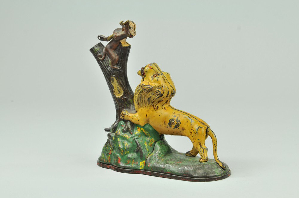 LION AND MONKEY MECHANICAL BANK: Kyser & Rex Co., designed by Louis Kyser & Alfred C. Rex, patented 7/17/1883. “Double Peanut” variety, 8.5" tall. Place a coin in the monkey’s hand, and touch a spring at the root of the tree. T