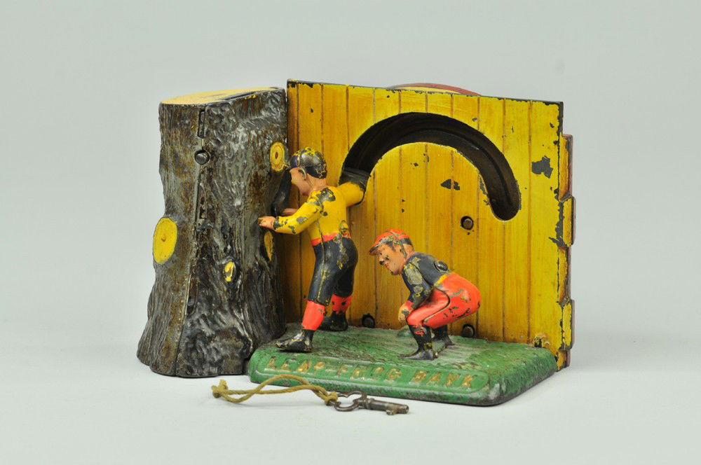 LEAP FROG MECHANICAL BANK: Shepard Hardware Co., designed by Peter Adams, patented 7/15/1890. Insert a coin in the slot at top of stump and slide the lever; one boy leapfrogs over the other and his right hand strikes a second l