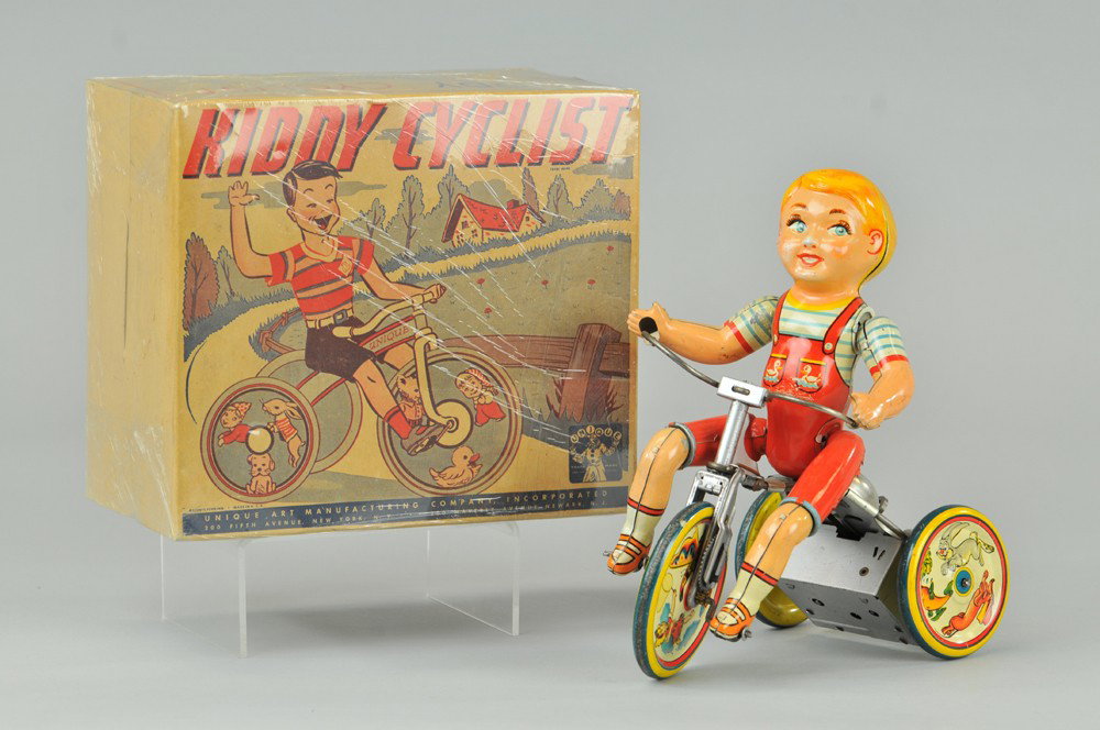 UNIQUE ART KIDDY CYCLIST IN ORIGINAL BOX: Litho tin wind-up toy with ringing bell, working. 1950's. Old store stock. 7 1/2" x 9". Box has minor paper loss, both (Exc. Cond.) 7 1/2" x 9".