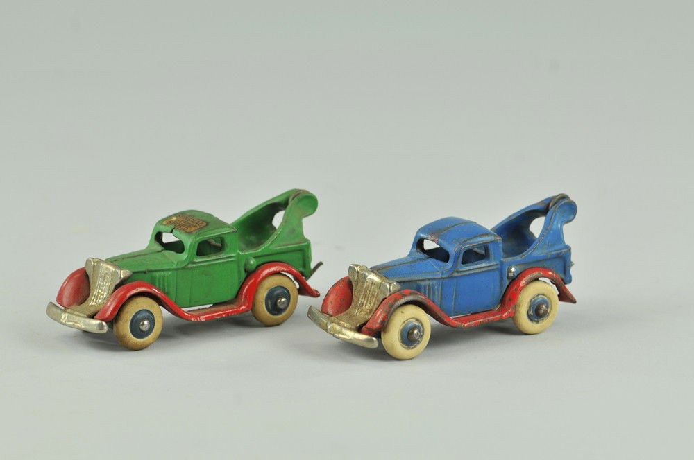 LOT OF TWO ARCADE WRECKERS: Cast iron, one blue and red, one green and red, both with nickel plated grilles and white rubber tires. Green has "Sundial Shoes" decal on roof. 4" l. (Exc. Cond.) 4" l.