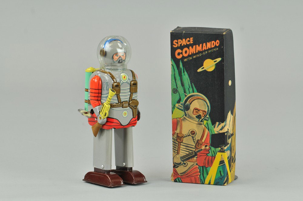SPACE COMMANDO ROBOT: Japan, lithographed tin, features celluloid dome with extensive cracks, great detail, grayish body, tanks on back. Comes with box lid. 8" h. Body (Exc. Cond.) 8" h.