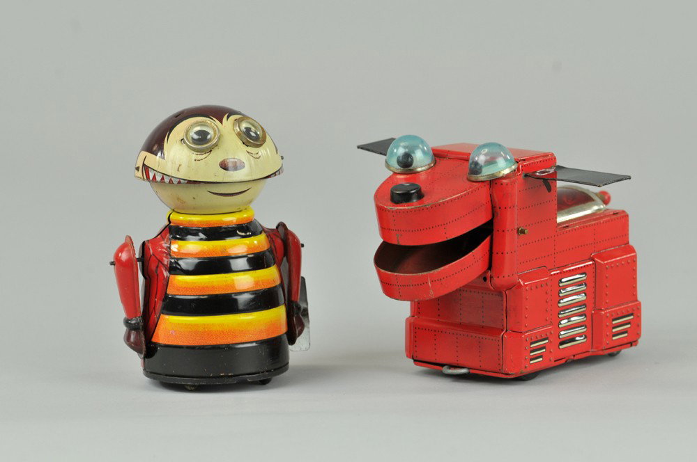 SPACE DOG AND CHOMPY THE BEETLE: Yoshiya, Japan, lithographed tin, depicts robotic dog done in red overall, black ears, friction drive, and wind-up beetle figure with toothy grin and beetle embossed wings. 5 1/4"h - 5 3/4" l. (VG Con