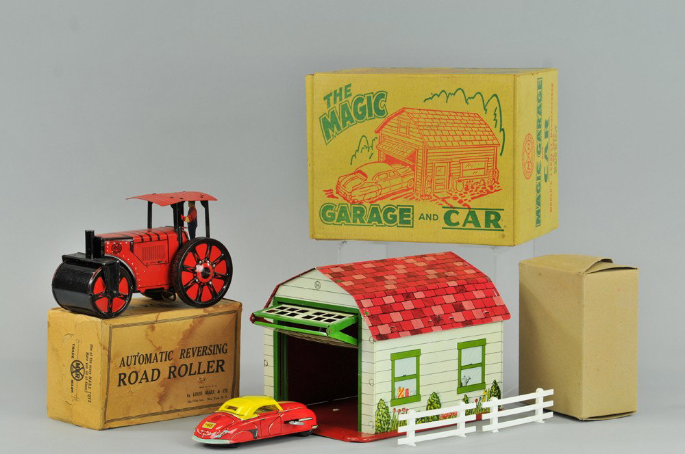MAGIC GARAGE AND ROAD ROLLER: Louis Marx, both boxed examples, lithographed tin, garage contains boxed car and fence pieces, road roller has standing driver, key wind operated. 8 1/2" - 10 1/2" W. Roller box stained and torn, some