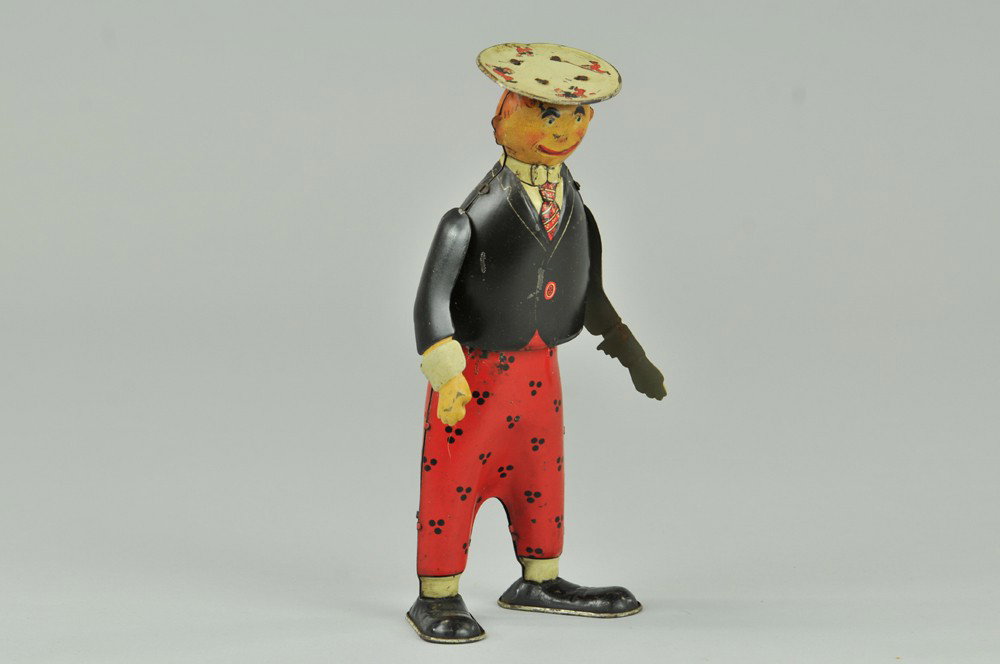 BOOB MCNUTT WALKER: Ferdinand Strauss, NY, lithographed tin, full figure in colorful graphic suit and flat top hat, clockwork activated. 8" h. Replaced arms, body (VG Cond) 8" h.