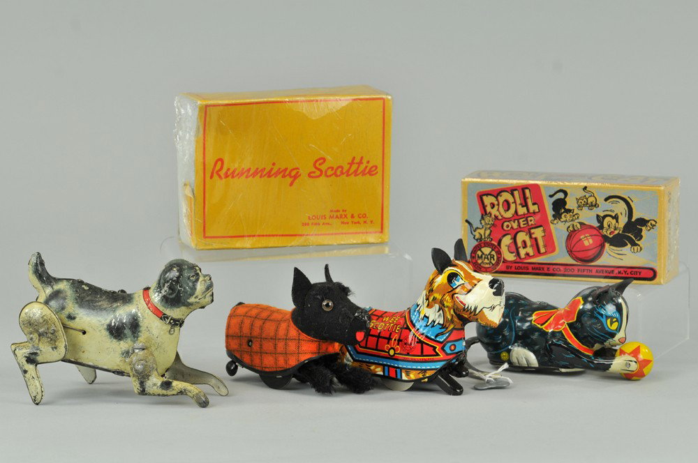 GROUPING OF DOG AND CAT TOYS: Lot includes: lithographed tin Wee Scottie jumping dog, plush covered Scottie toy dog, and Roll Over Cat with box. 5" - 5 1/2" l. Scottie box tattered (Poor cond); toys (VG - Exc. Cond) Inv# 0430, 130