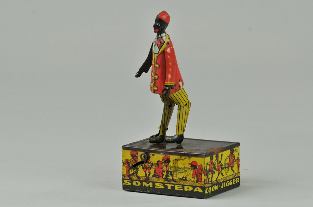 SOMSTEPA JIGGER: Marx, lithographed tin, depicts dancing figure on square base, very colorful graphics, clockwork mechanism. 8" h. One replaced arm, corrosion to base, (Good Cond.) 8" h.
