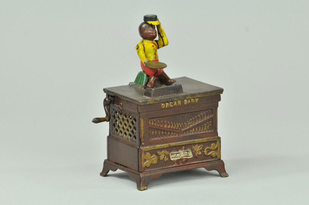 ORGAN MECHANICAL BANK (SMALL): Kyser & Rex Co., designed by Louis Kyser & Alfred C. Rex, patented 5/13/1881. This bank is calculated to highly amuse children, as it is a musical toy as well as a savings bank. When the handle is tur