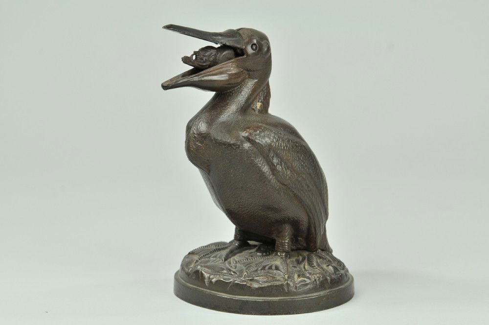 PELICAN (MAN THUMB'S NOSE): Man thumbing Nose in Mouth, J & E Stevens Co., designed by John Gerard, patented 10/15/1878. Close the beak of the pelican, place a coin in the slot on the top of his head and press. This causes the b