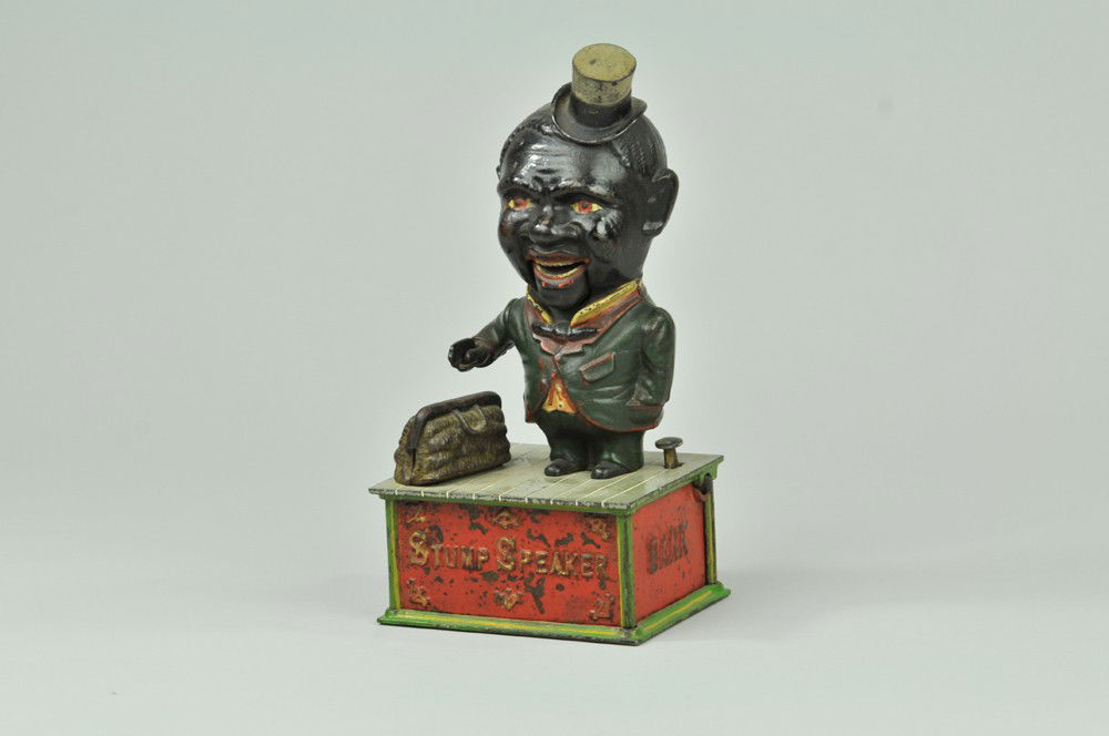 STUMP SPEAKER MECHANICAL BANK: Shepard Hardware Co., designed by Charles Shepard & Peter Adams, patented 11/16/1886. A very comical appearance is given to the face the lower jaw being balanced on pivots and easily kept in motion. T