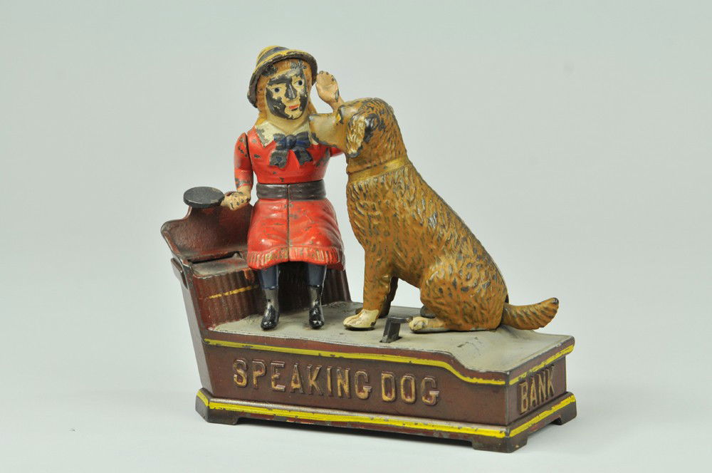 SPEAKING DOG MECHANICAL BANK: Red Dress, Shepard Hardware Co., designed by Charles Shepard & Peter Adams, patented 10/20/1885. The coin is placed in a plate held by the girl. The thumb piece is pressed upon, when the girl’s arm