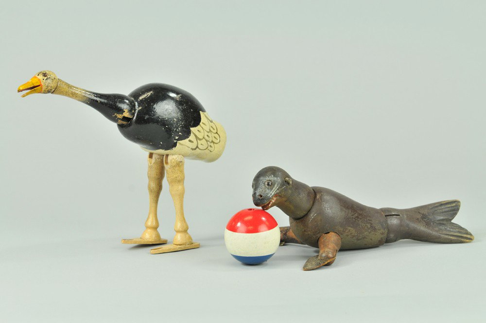 SCHOENHUT OSTRICH AND SEAL: Both have glass eyes, Ostrich is painted black over white, with open mouth and painted feathers, Seal is brown colored with leather foreflippers. 8 1/2" l. (Good Cond) 8 1/2" l.
