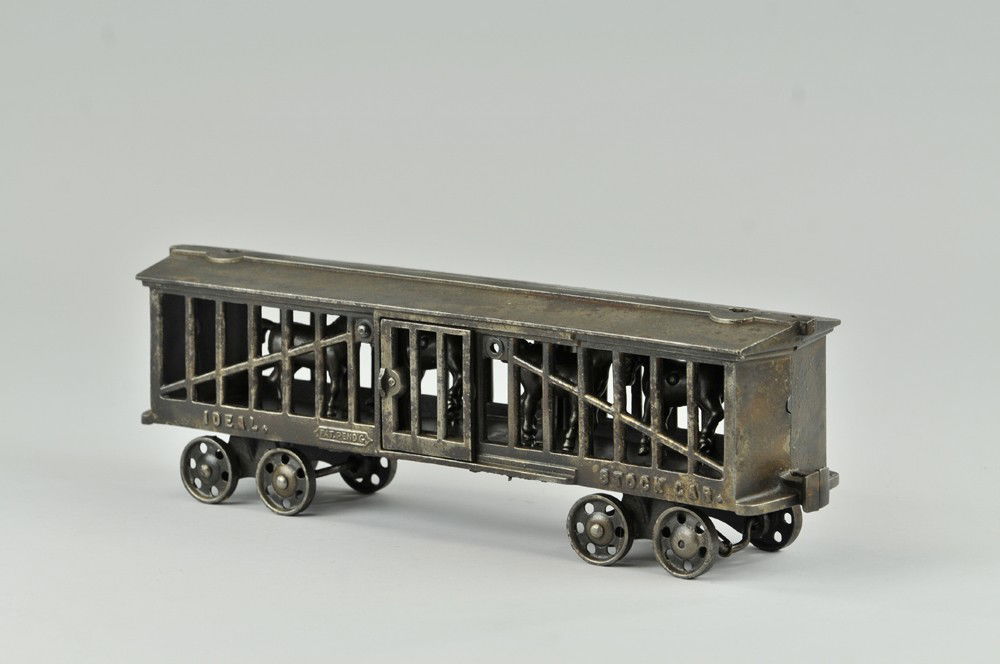 IDEAL STOCK CAR: Cast iron car is nickel plated with wear to finish, four horses stand on interior floor and are articulated when toy is pulled along floor, embossed sides, figure is missing from roof, a scarce item.