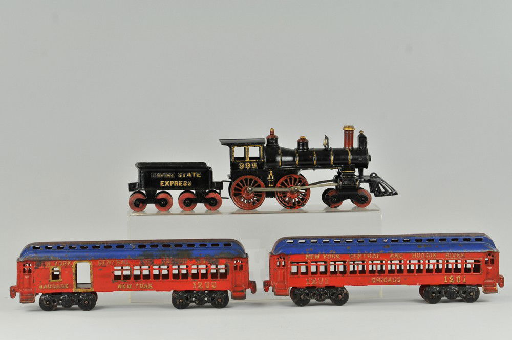 KENTON FLOOR TRAIN: Cast iron, circa 1910, one of Kenton's top of the line trains, the 4-0-4 locomotive finished in black with red accents and gold piping fitted with handsome cowcatcher, cab is marked 999, tender is mar