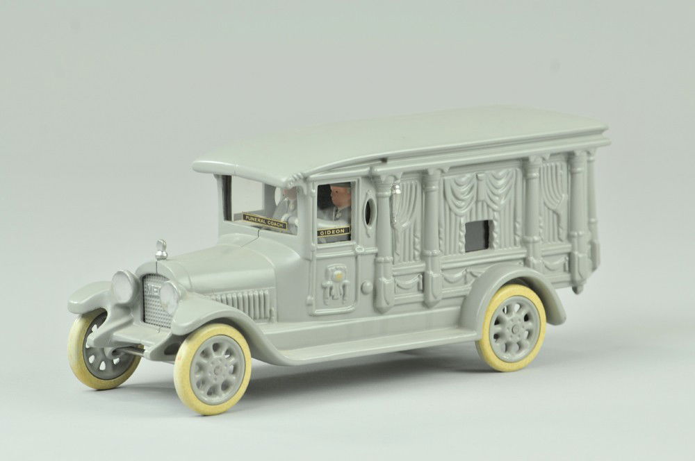 CAST IRON TOY FUNERAL CAR: Motorcade Toys, cast iron, painted in grey overall, lot includes funeral car with opening rear doors, drivers and plexi glass windows stenciled "Gideon", great casting effects. 10 1/2" l. (Mint Cond.)