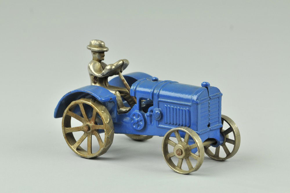 McCORMICK DEERING 10-20 FARM TRACTOR: Kilgore, a well cast and very rare example, cast iron, painted in blue overall, features nickel driver and spoke wheels, lug treads on rear. Ex. Dick Ford Collection. 5 3/4" l. (Pristine Cond.) 5 3/4"