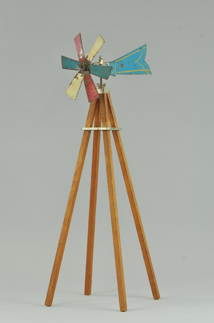 ARCADE WINDMILL TOY: Windmill made of wood support, pressed steel fan blades in red, white, and blue, and held by nickel hardware, decal appears on one blade. 26" h. (Good Cond.) 26" h.