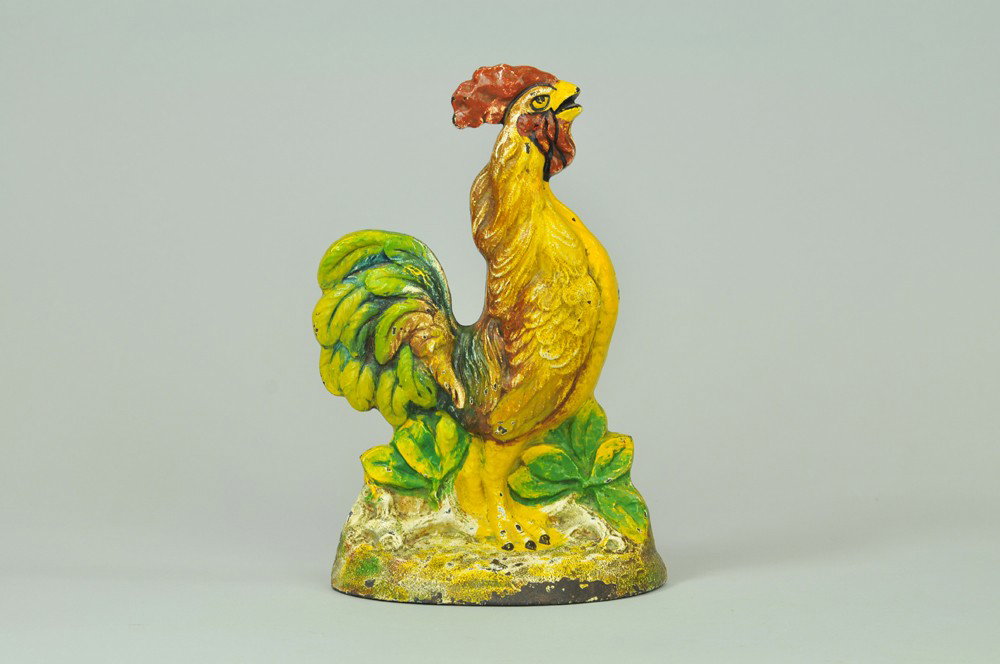 CROWING ROOSTER DOORSTOP: Depicts very colorful, cast iron crowing rooster w/embossed flowers on base, very vibrant piece, beautiful paint variation. 10 1/4" x 6 5/8". (Pristine Cond.) 10 1/4" x 6 5/8".