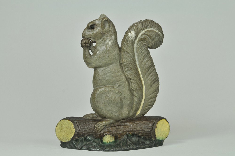 SQUIRREL WITH NUT DOORSTOP: Bradley & Hubbard, depicts cast iron squirrel on stump eating nut, great size & realistic design. 11 1/2" 9 7/8". (Pristine Cond.) 11 1/2" 9 7/8".