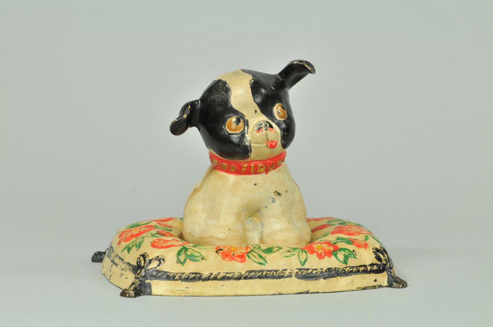 BOSTON TERRIER "FIDO" ON FLORAL CUSHION DOORSTOP: Hubley, cast iron, full figured adorable black & white pup with "Fido" embossed on red collar, sitting atop cushion, Grace Drayton design. 6" h. (Pristine Cond.) 6" h.
