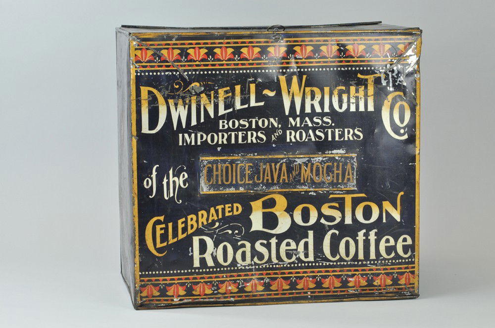 DWINELL WRIGHT CO. COFFEE BIN: Country store tin Roasted Coffee can, black with gold and red letters, Java name plate removable for varied flavors. 12" x 17". Denting and paint flaking. (VG Cond) 12" x 17".