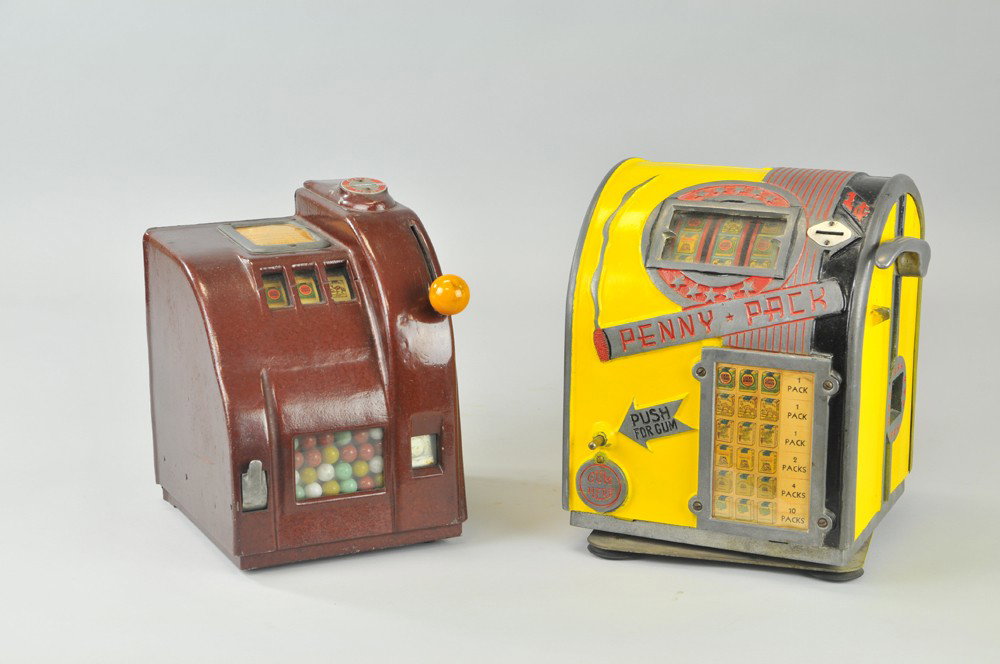 LOT OF TWO CIGARETTE SLOT MACHINES: Both Die-Cast one repainted, each has glass view panels, includes, Penny-Pack, and Jiffy Model. 10"- 11" h. Penny-Pack repainted. 10"- 11" h.