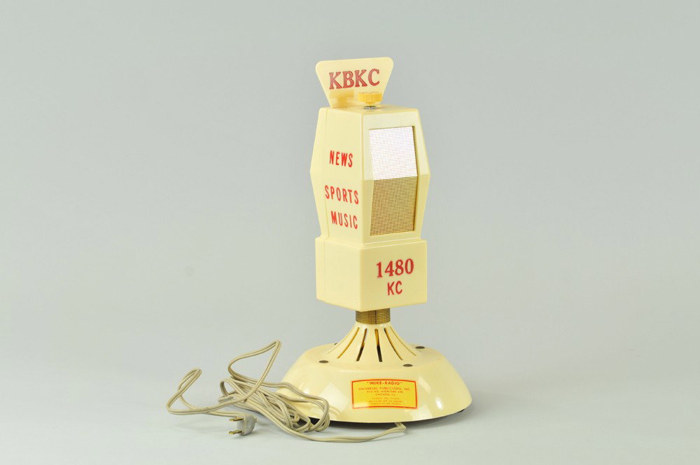 "MIKE RADIO": Station KBhC, 1480 hC, early white plastic case, microphone for radio station, decal on front, not tested, but said to work. 14" h. (Exc. Cond) 14" h.