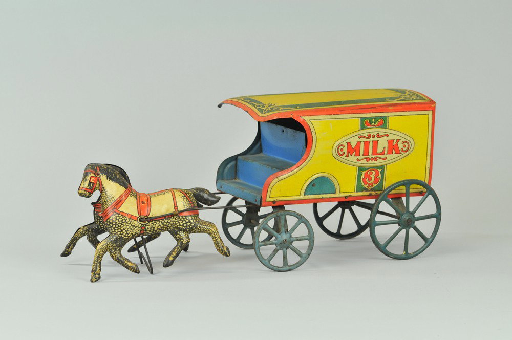 CONVERSE HORSE DRAWN MILK WAGON: c. 1918, lithographed tin, large scale wagon reads, "MILK" on sides, drawn by two horses, blue spokes on wagon, open bench seating. 17" l. (VG Cond) 17" l.
