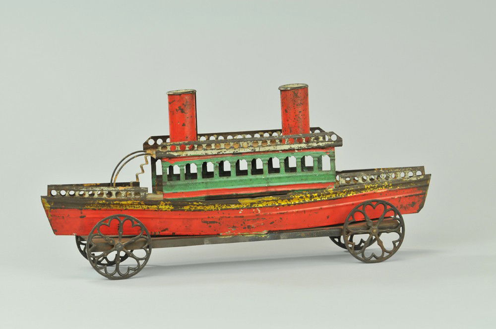 EARLY TIN SHIP FLOOR TOY: Interesting pull toy, painted in red and green, two stacks, steps to upper deck level, cast iron spoke wheels, mfg. unknown. 15 "l. Paint flaking. 15 "l.