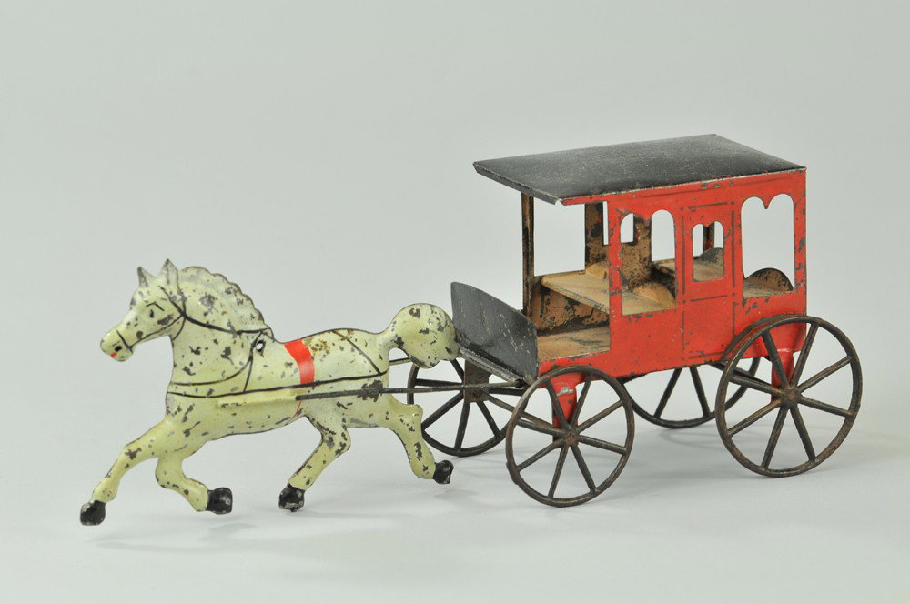 GEORGE BROWN TWO SEAT ENCLOSED BRAKE: Scarce example, hand-painted tin, enclosed red wagon with cast spoke wheels, drawn by solo white horse. The window cutout designs along with the shape of the horse were George Brown's designs and help
