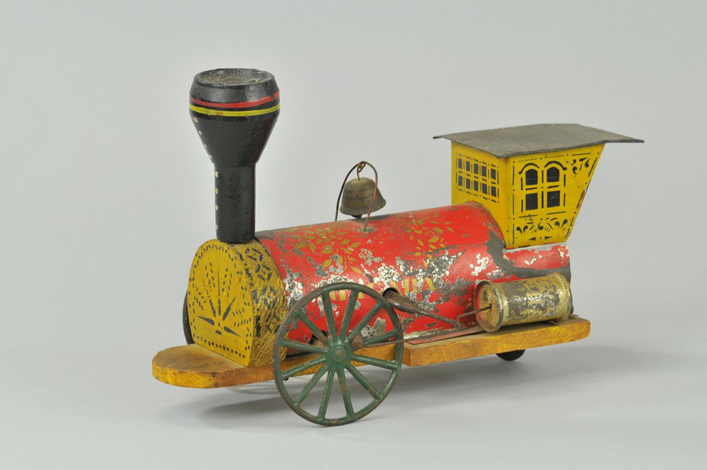 GEORGE BROWN "NIAGARA" CLOCKWORK LOCOMOTIVE: Hand-painted and stenciled tin and wood with cast iron wheels, clockwork mechanism with original, stenciled floral patterns on boiler. Provenance: One of only two toy trains retained by Ward Kimball's