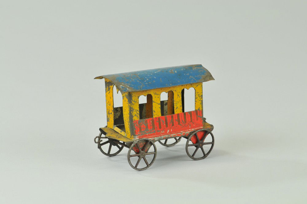 AMERICAN TIN PASSENGER COACH: Painted tin with cast iron wheels, bright and colorful paint scheme overall, would go with a floor train set- c. 1890. 4" l. Overall, (Good Cond) 4" l.