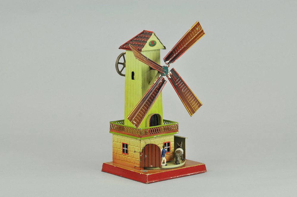 DOLL WINDMILL WITH MILLER AND DONKEY: Germany, hand-painted overall, flywheel activates circular base allowing figures to enter and exit windmill. 10" x 11". Some paint flaking. (VG Cond) 10" x 11".