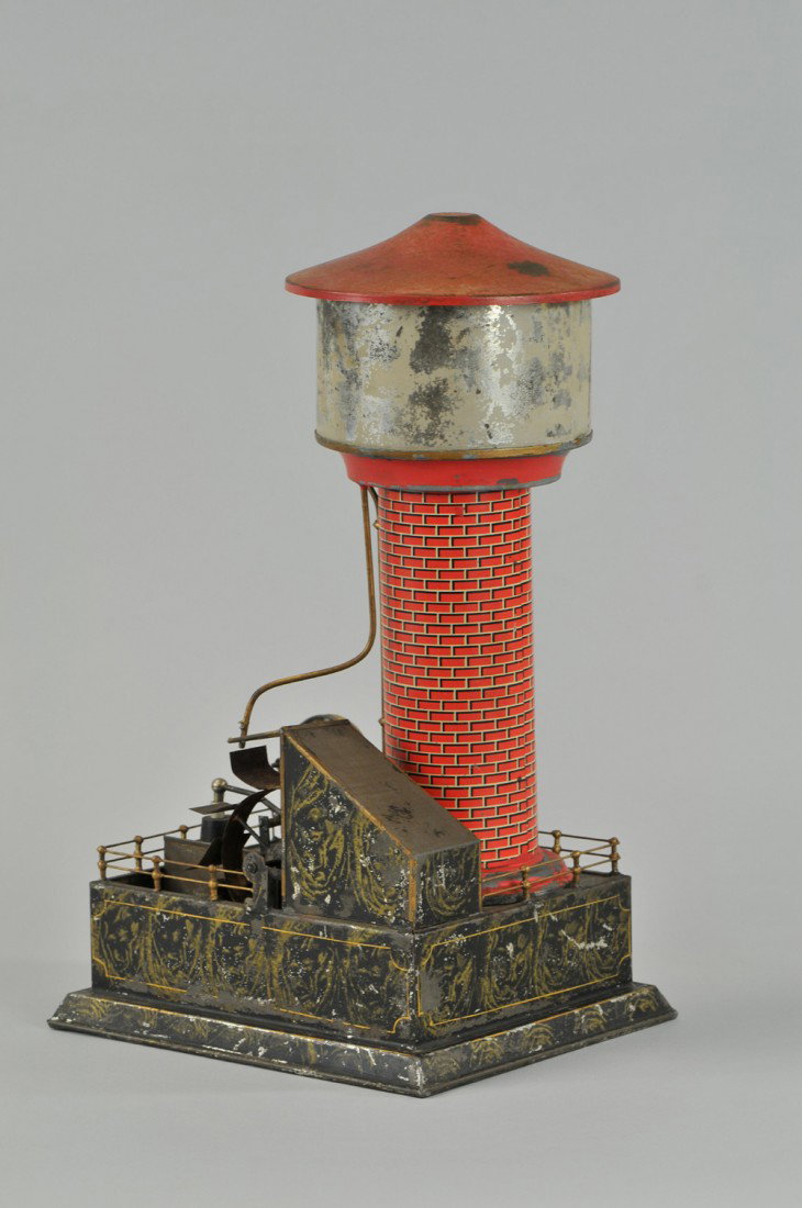 CARETTE WATER TOWER: c. 1920, Germany, lithographed tin, features reservoir and side waterwheel, railed base, very desirable accessory. 16" h. Paint wear to litho, overall (Good Cond) 16" h.