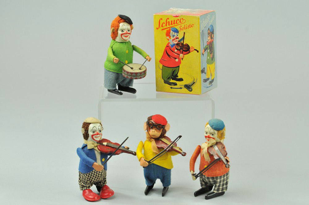 FOUR SCHUCO MUSICIAN TOYS: Germany, includes one playing fiddle, clown and monkey violinists and clown drummer, all in classic felt outfits together with one box. 4 1/2" h. Tear to back of one head, overall (Exc. Cond.) 4 1/2"