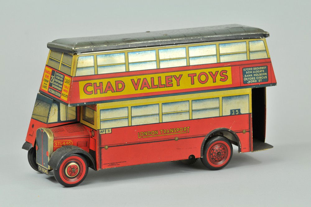 CHAD VALLEY TOYS BISCUIT BUS TIN: Carr's Double Decker, lithographed tin features bright overall graphics and opening lid for biscuit retrieval, extensive detail to driver's area, rear of bus simulates stairwell. 9 3/4" l. (Exc. Cond)