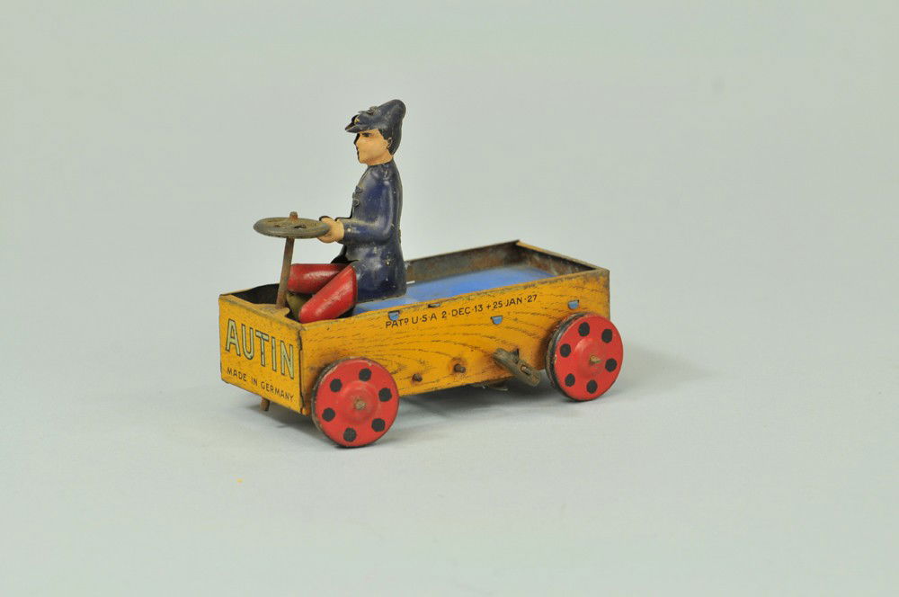 LEHMANN AUSTIN: Germany, lithographed and hand painted tin, clockwork mechanism, depicts American boy in pedal car. 4 1/4" l. Some corrosion to litho. (VG Cond) 4 1/4" l.