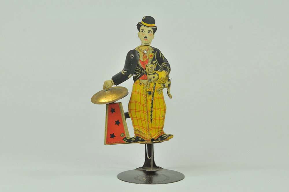 CHARLIE CHAPLIN CYMBAL PLAYER: Litho tin squeeze toy, Charlie holds cat and bangs cymbals when squeezed, Distler trademark, made in Germany, c. 1920. 7" h. (Exc. Cond) 7" h.