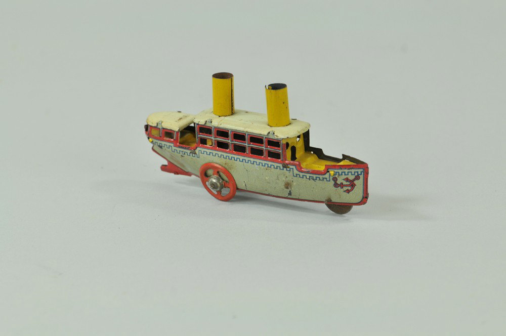FISCHER OCEAN LINER PENNY TOY: Lithographed tin, features two yellow stacks, upper deck cabin, anchor graphics on hull. 4 1/4" l. (VG Cond) 4 1/4" l.