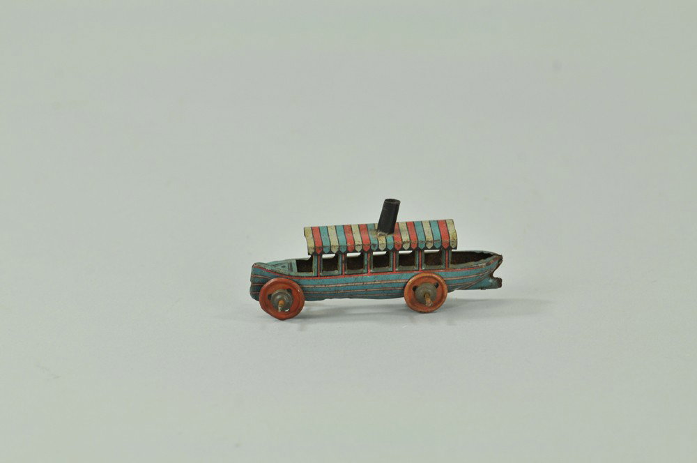 MEIER RIVER BOAT PENNY TOY: Germany, lithographed tin, striped canopy roof and hull, single stack on roof, red disc wheels for rolling. 3" l. (VG Cond) 3" l.