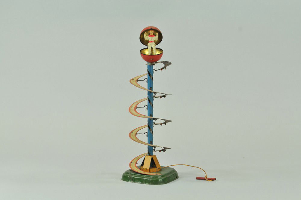 FERNAND MARTIN MYSTERY BALL TOY: France, inspired by an actual European circus act, lithographed tin, unique spiral action and surprising figure revelation at final stop, works well. 14 1/2" h. (Exc. Cond) 14 1/2" h.