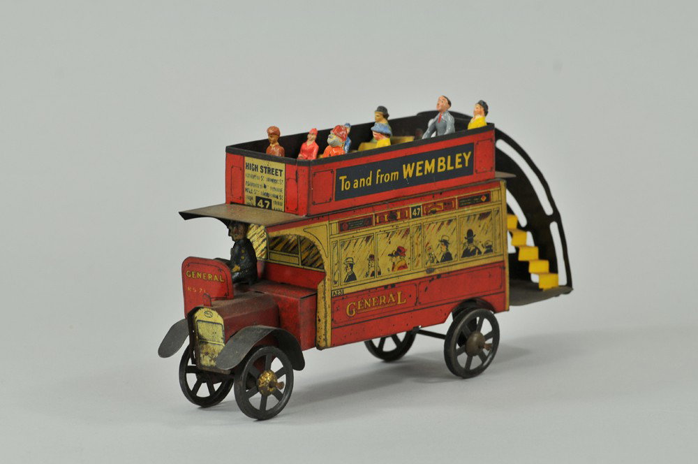 ENGLISH DOUBLE DECKER BUS: England, mfg. unknown, a scarce example, great graphic depiction of passengers at windows, upper deck bench seating, an early version reads "To and from Wembly". 11" l. Some wear to litho. (VG Cond) 1