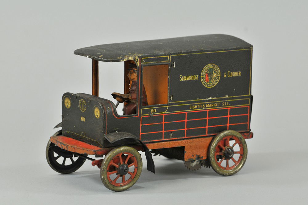 HANS EBERL "STRAWBRIDGE & CLOTHIER" DELIVERY VAN: Germany, c. 1920's, an early promotional toy for popular Philadelphia department store, lithographed tin, black body, red frame, split door with opening bottom half, seated driver. 7 1/2" l. Some chip