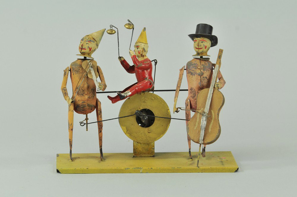 GUNTHERMANN CLOWN MUSICIANS: Hand painted, each depicted with instrument in hands, clockwork mechanism allows players to play their string instruments while center clown plays the bells, emits "PLINK-PLUNK" music. 9 1/2" l. Repai