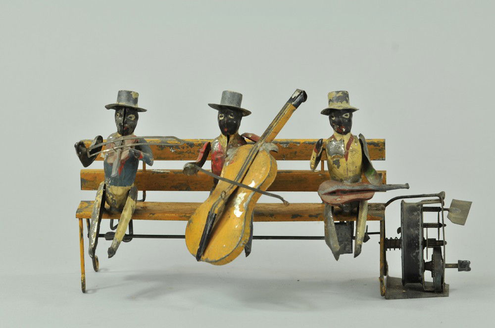 THREE MUSICIANS SEATED ON BENCH: Germany, attributed to Gunthermann, hand painted figures depicted with instrument in hand, each seated on long bench, clockwork driven, scarce example. 10" l. Wear to paint. (Good - VG Cond) 10" l.