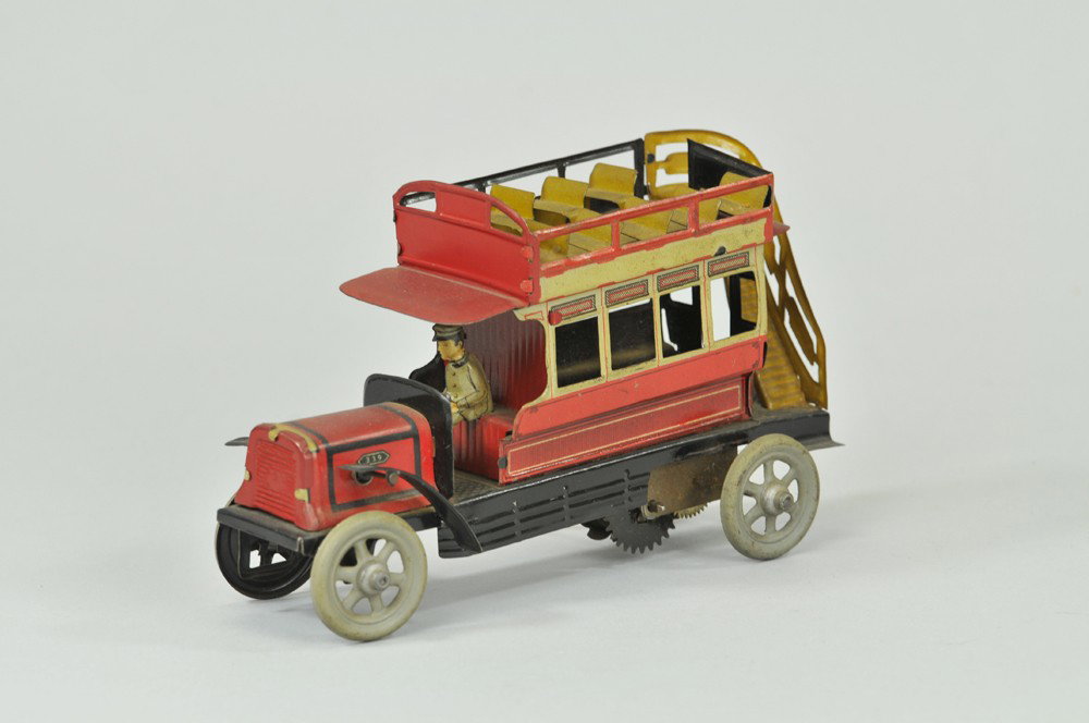 DOUBLE DECKER BUS: Germany, c. 1920's, lithographed tin, seated driver, railed upper deck seating, rear stairway, spoke wheels, key wind operated. 7 1/4" l. (Exc. Cond) 7 1/4" l.